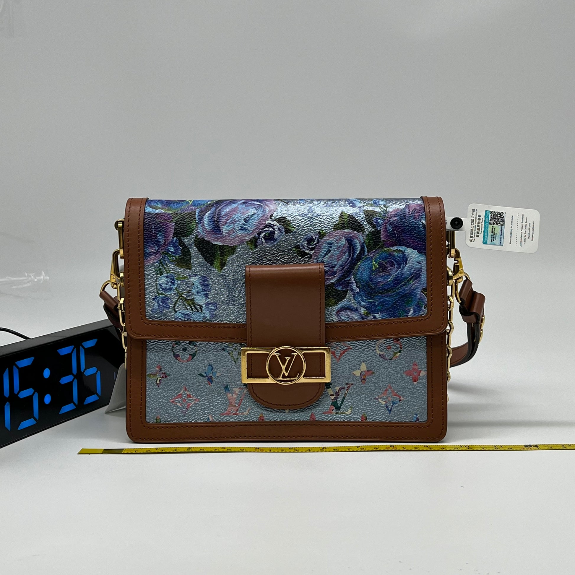 Louis Vuitton LV Garden Dauphine MM bag features a striking metallic blue monogram canvas with a floral print and natural leather trim