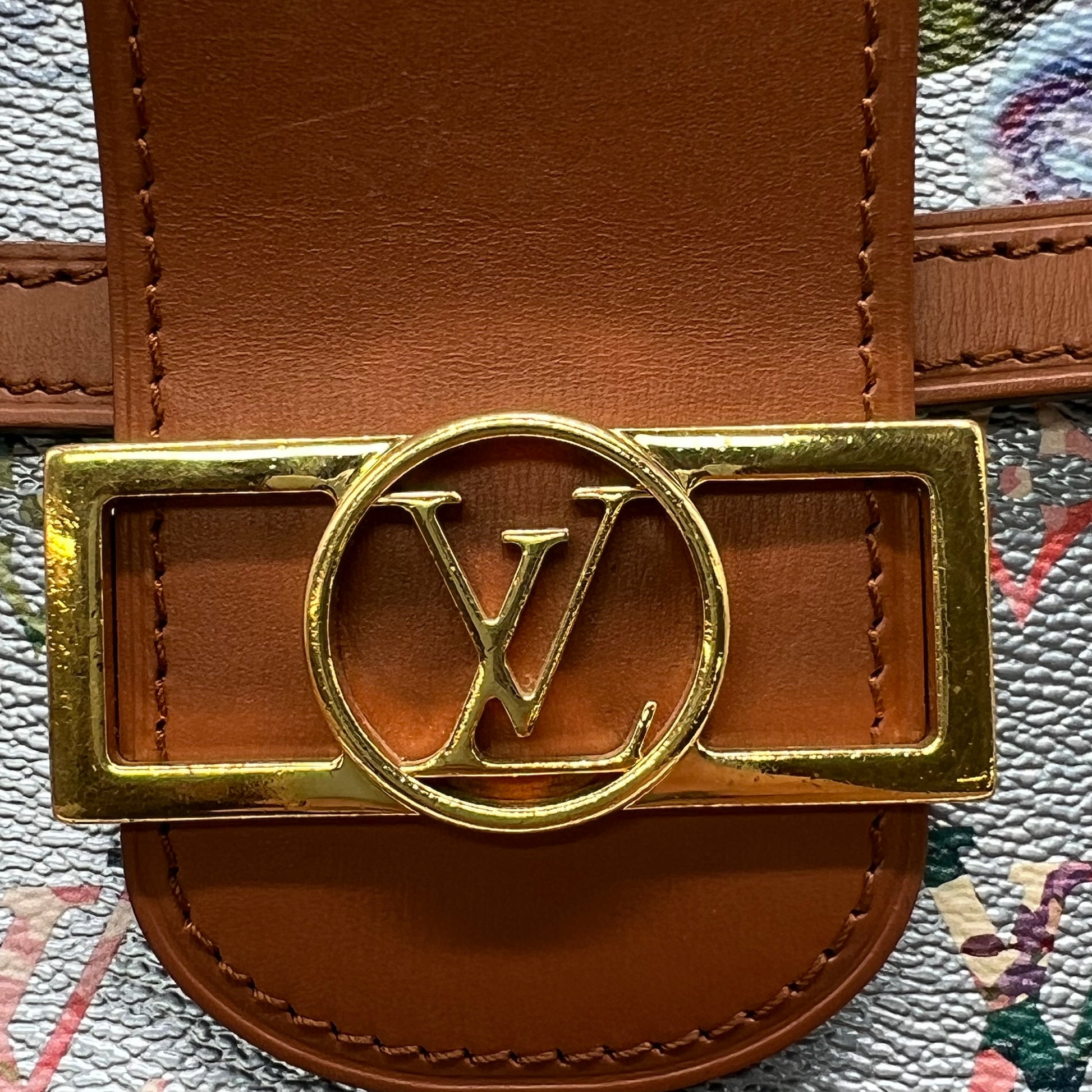 Louis Vuitton LV Garden Dauphine MM bag features a striking metallic blue monogram canvas with a floral print and natural leather trim