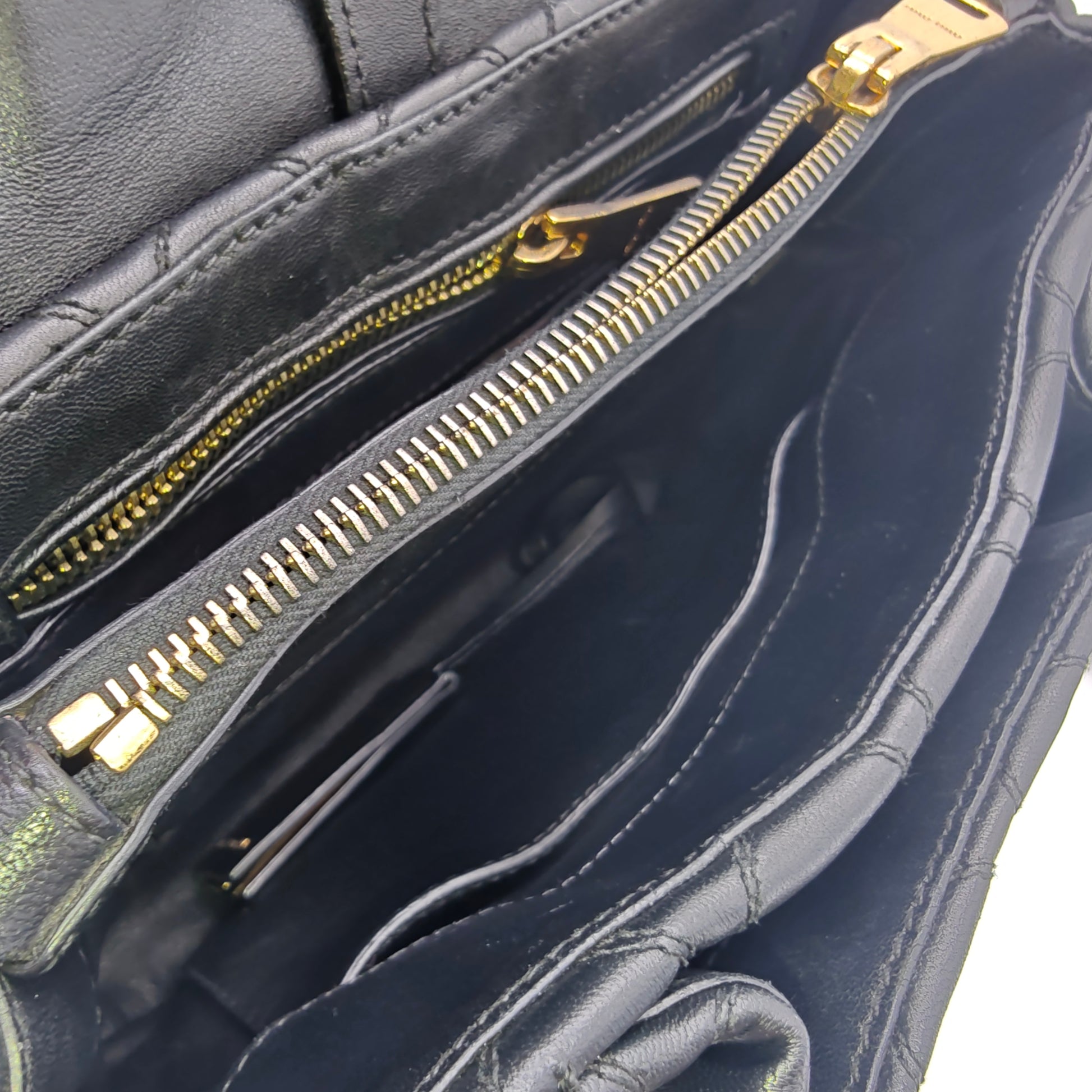 Miu Miu Matelassé 2-way leather bag in black and gold gisel