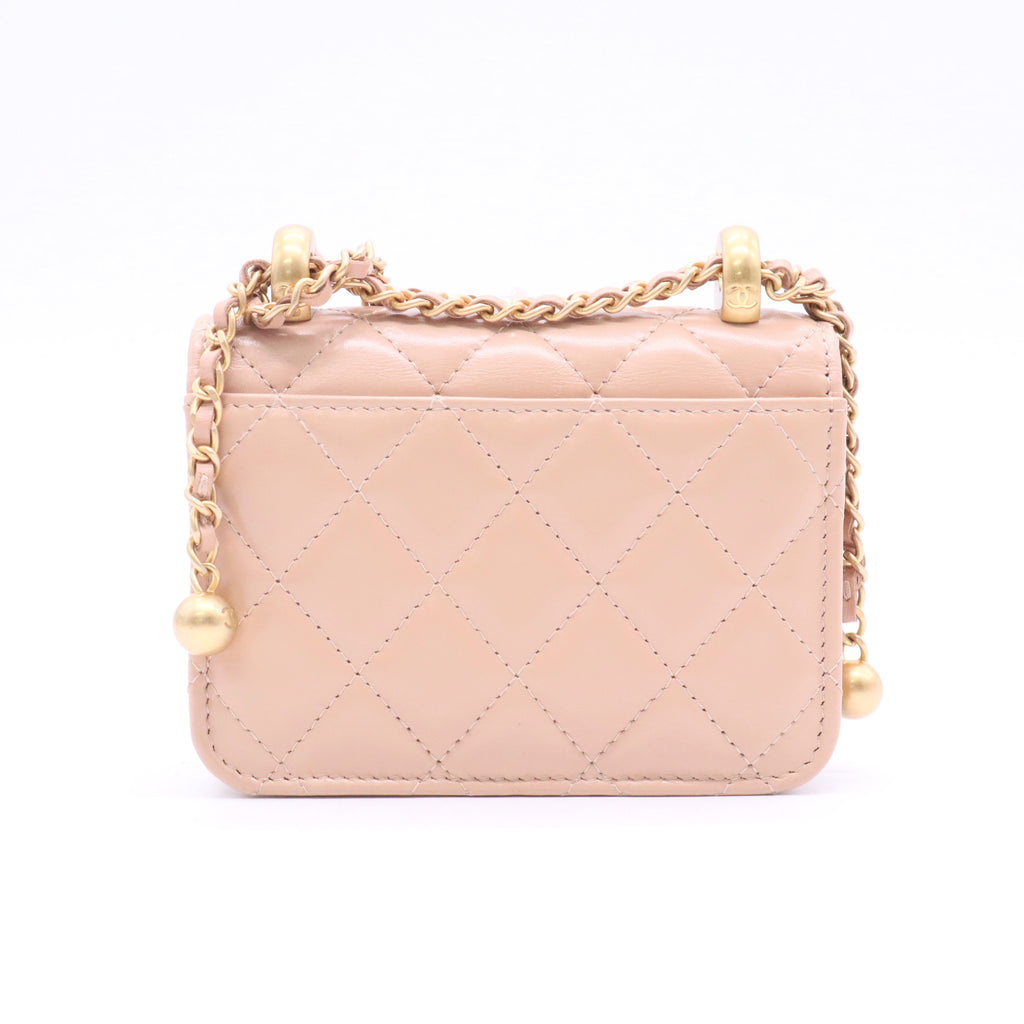 CHANEL mini shoulder bag in nude khaki leather with quilted pattern featuring a chain strap and gold hardware twins