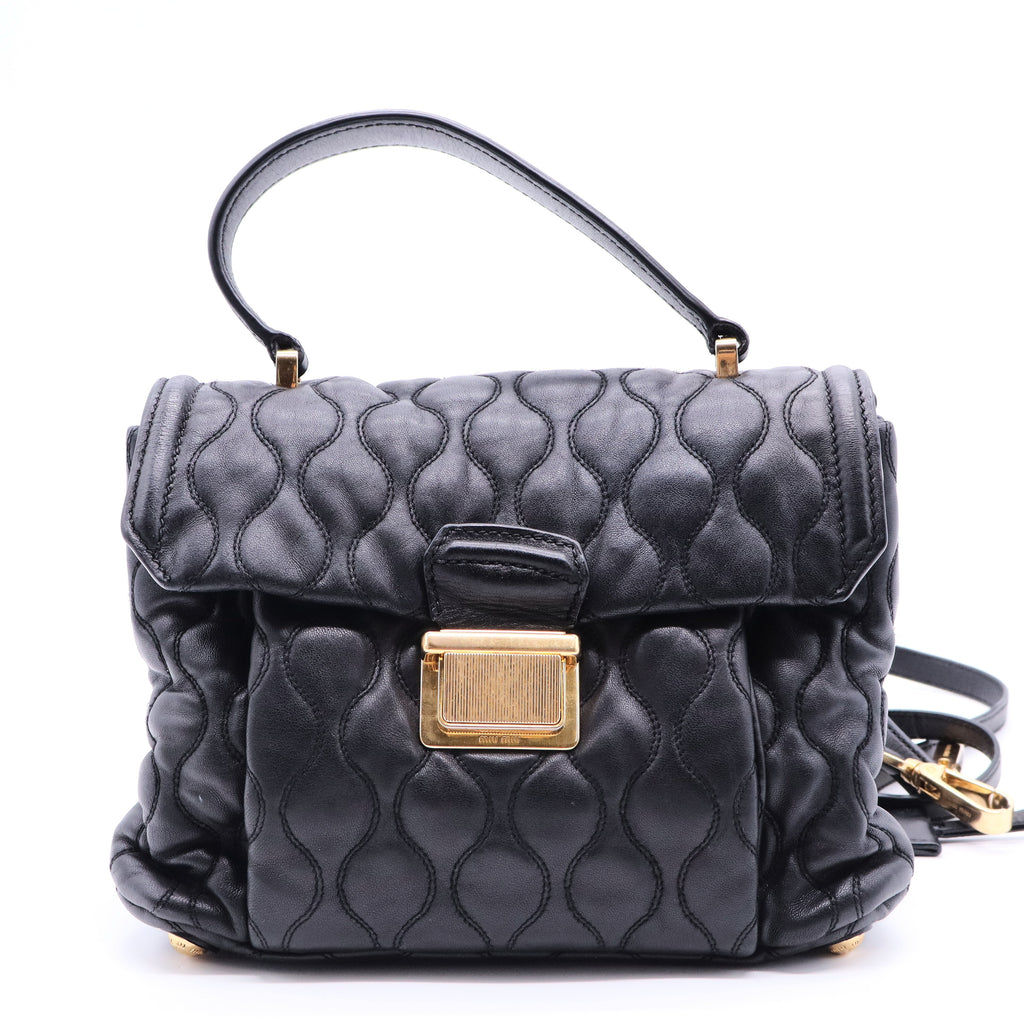 Miu Miu Matelassé 2-way leather bag in black and gold gisel