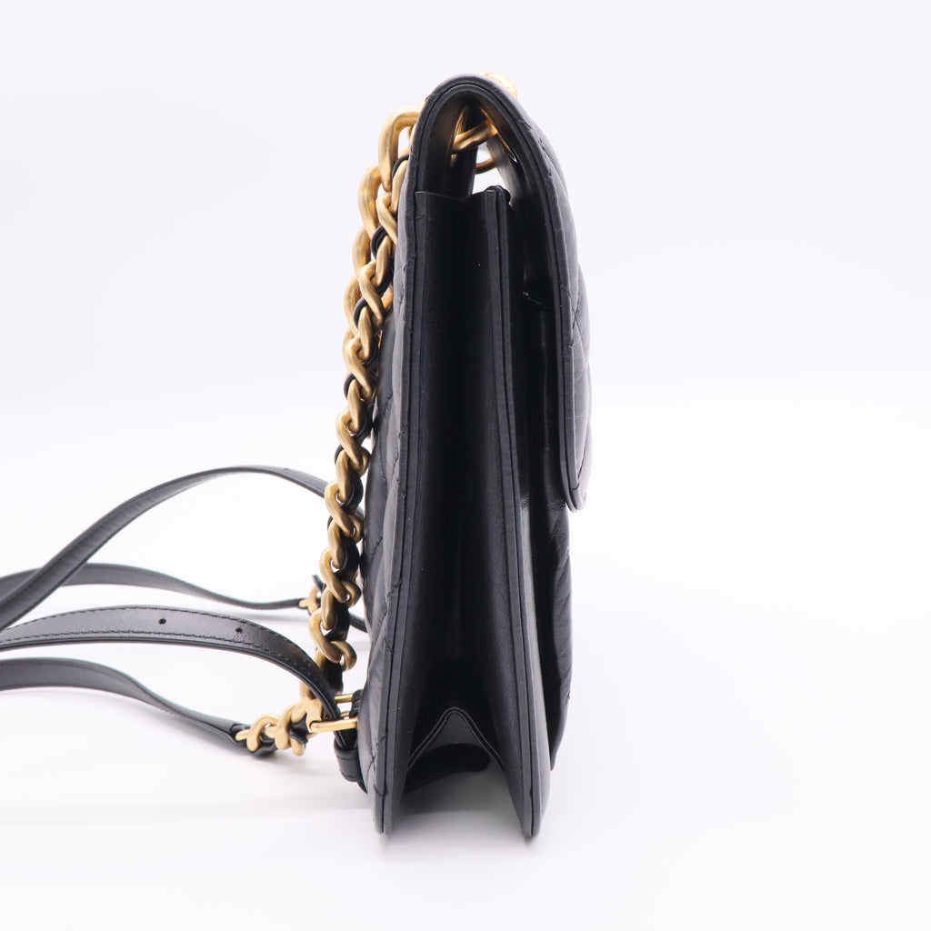 Chanel Flap Backpack in black leather with gold-tone hardware twins