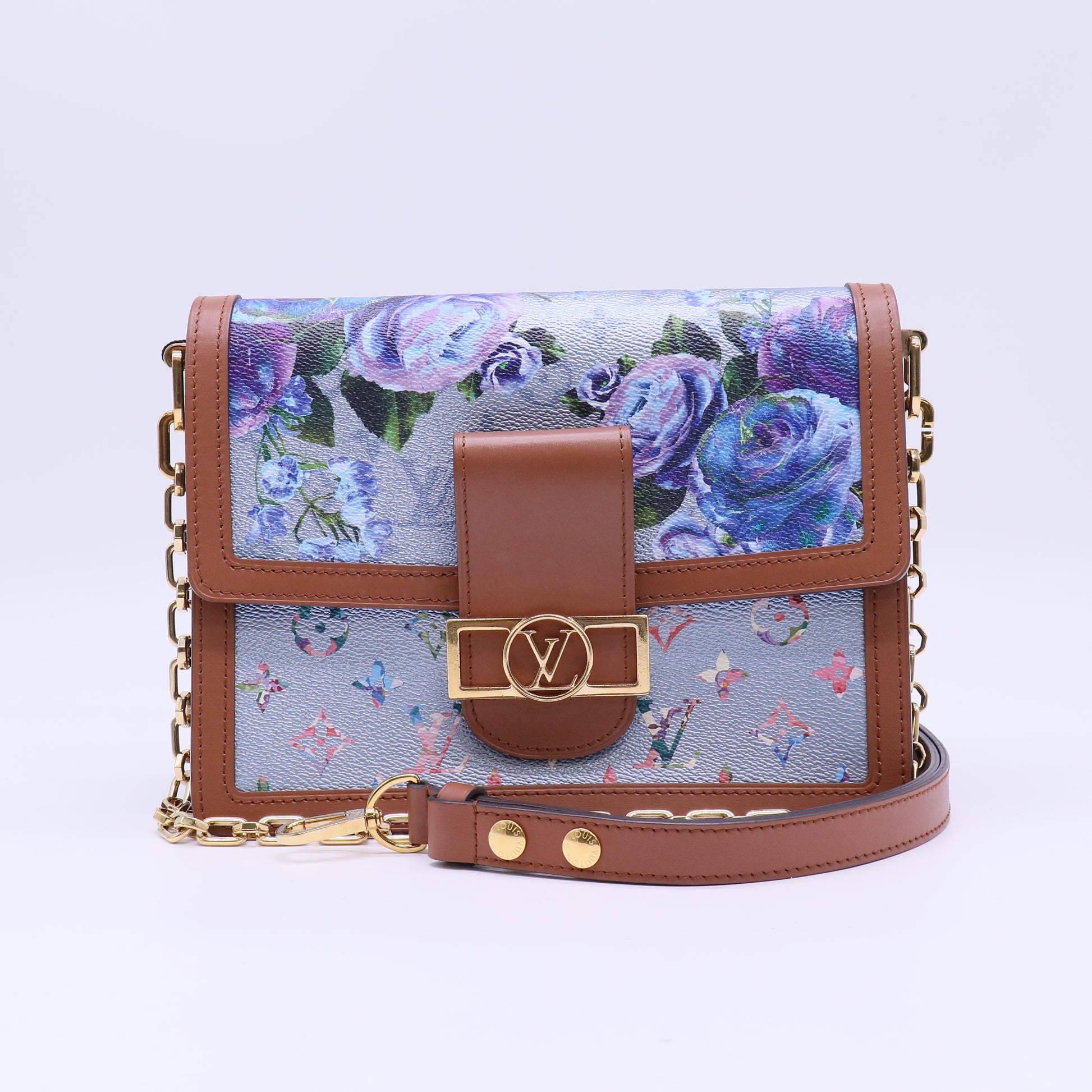 Louis Vuitton LV Garden Dauphine MM bag features a striking metallic blue monogram canvas with a floral print and natural leather trim