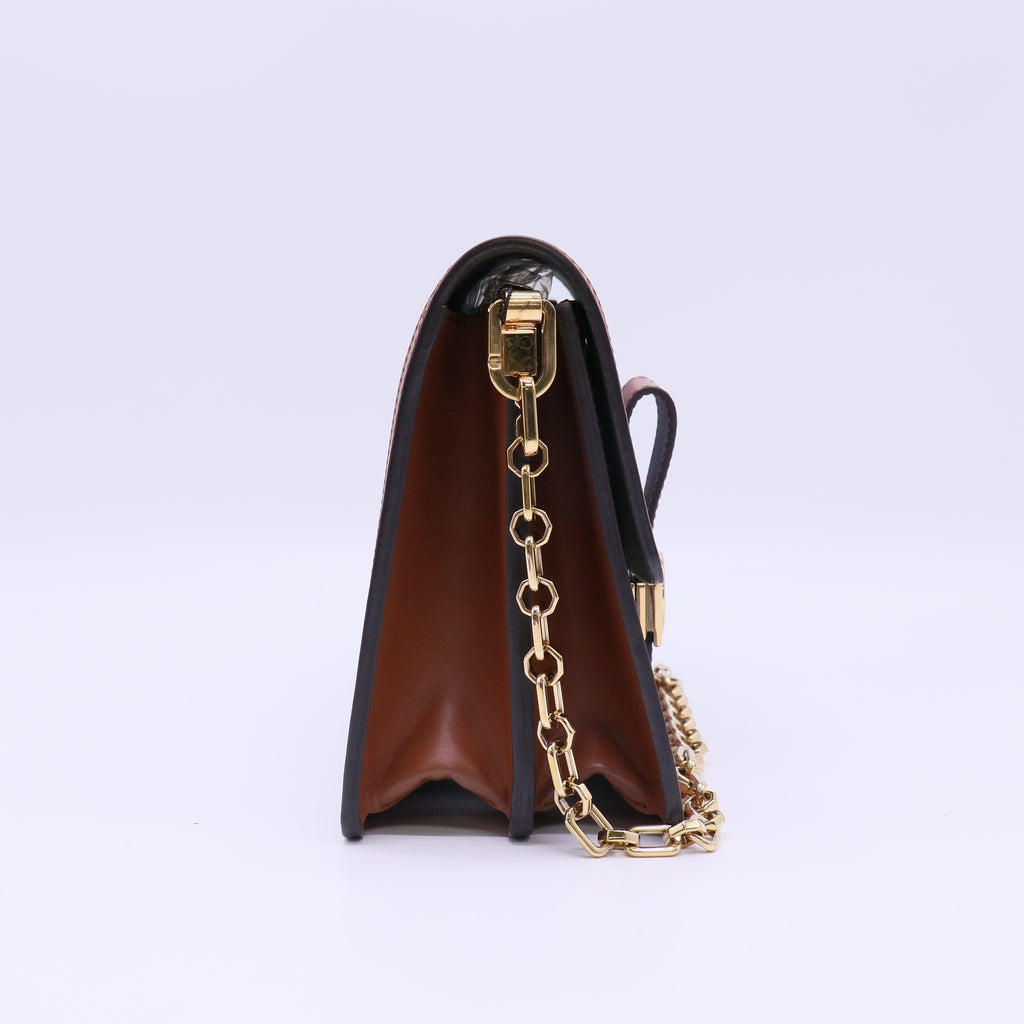 Louis Vuitton LV Garden Dauphine MM bag features a striking metallic blue monogram canvas with a floral print and natural leather trim