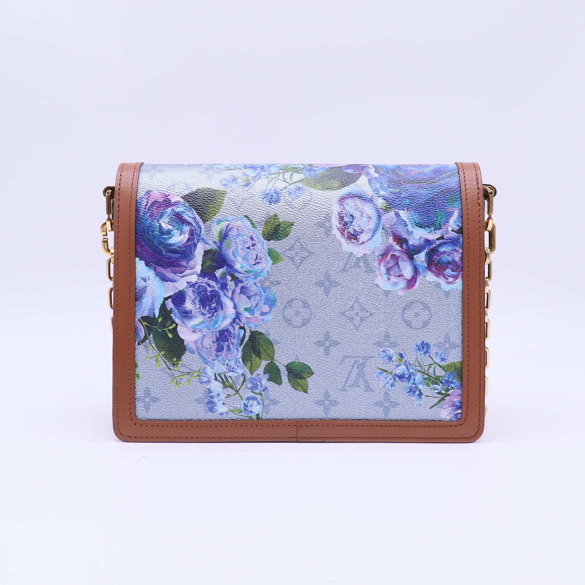 Louis Vuitton LV Garden Dauphine MM bag features a striking metallic blue monogram canvas with a floral print and natural leather trim