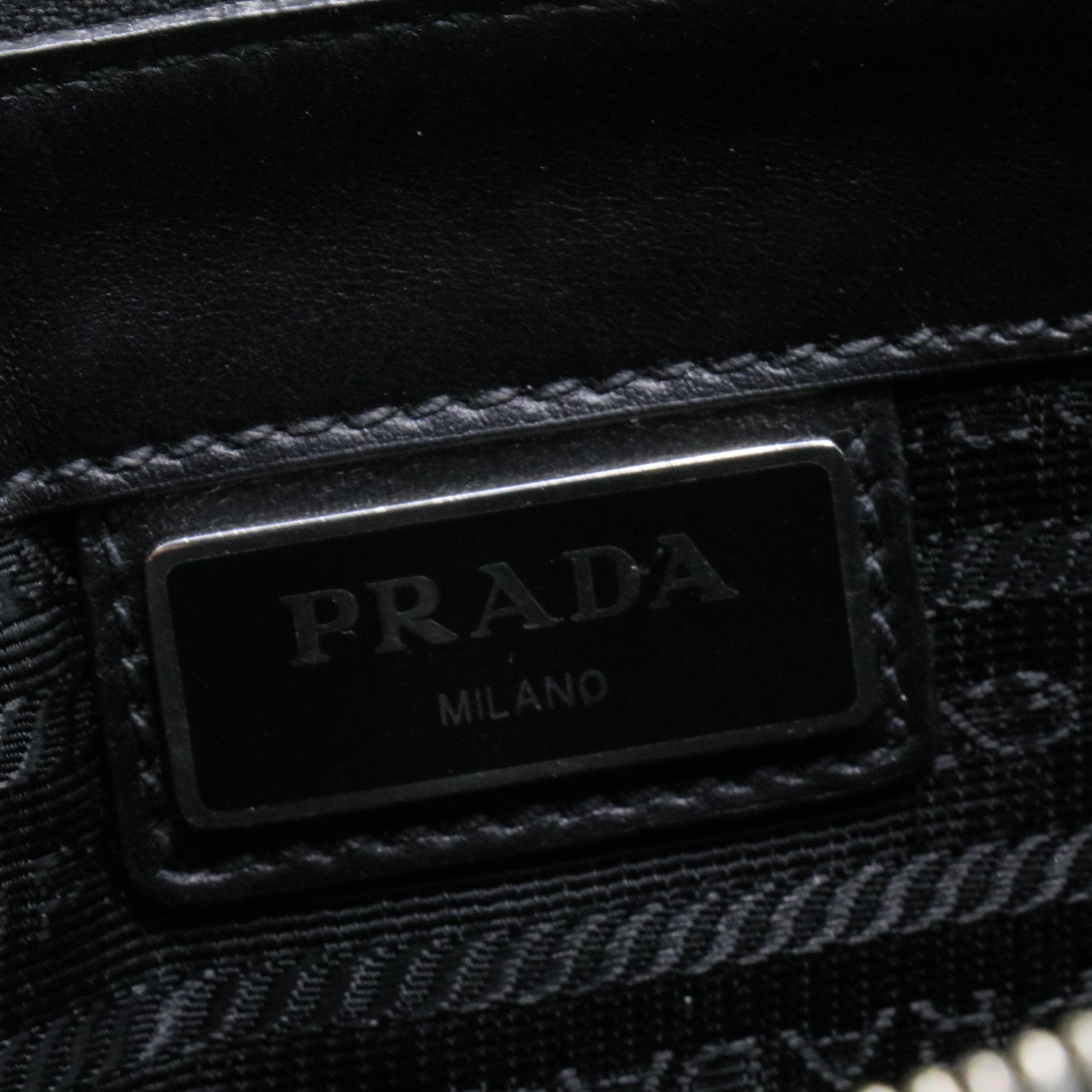 Saffiano enamel triangle logo zipped clutch